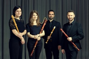 The Flautadors in black, holding instruments